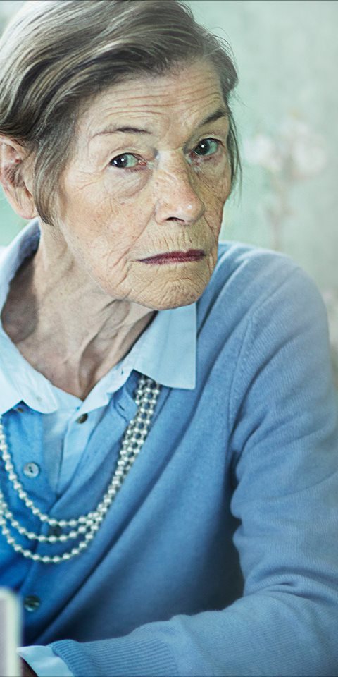 Close up of woman sitting looking at the camera.