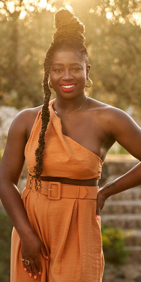 Woman posing and smiling at the camera.